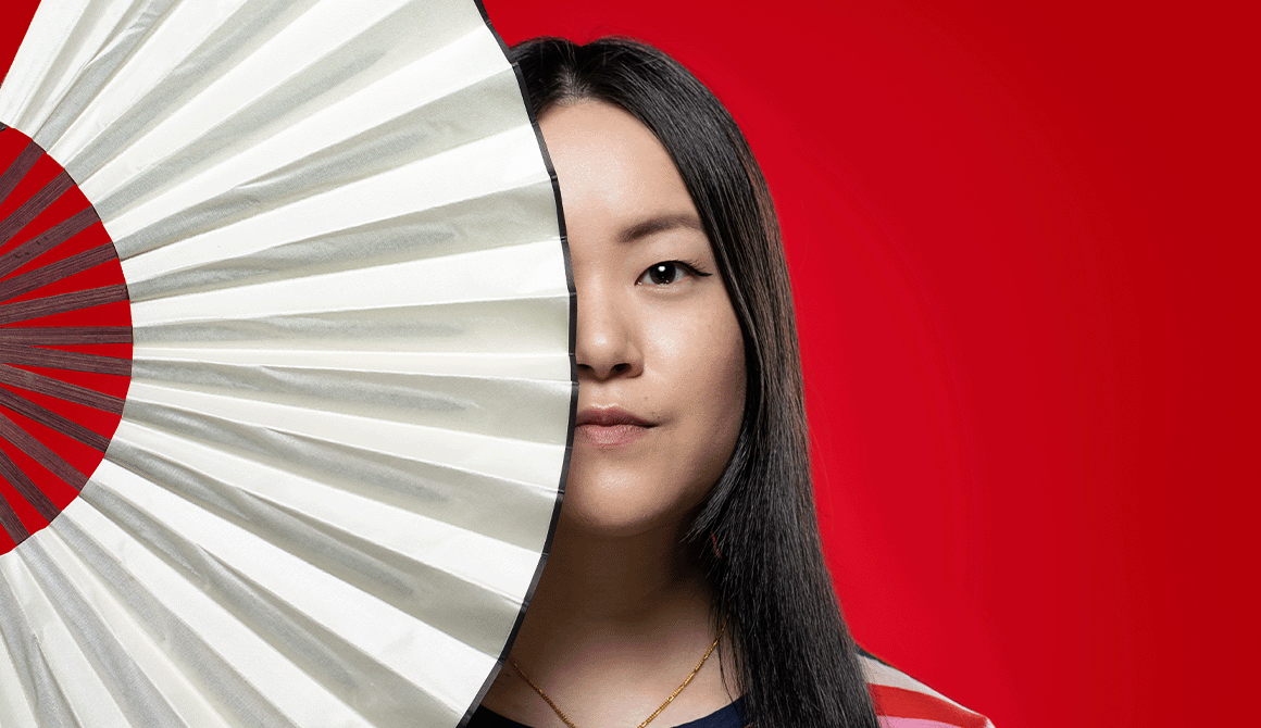 The Chinese Lady holding a fan with solid red backdrop